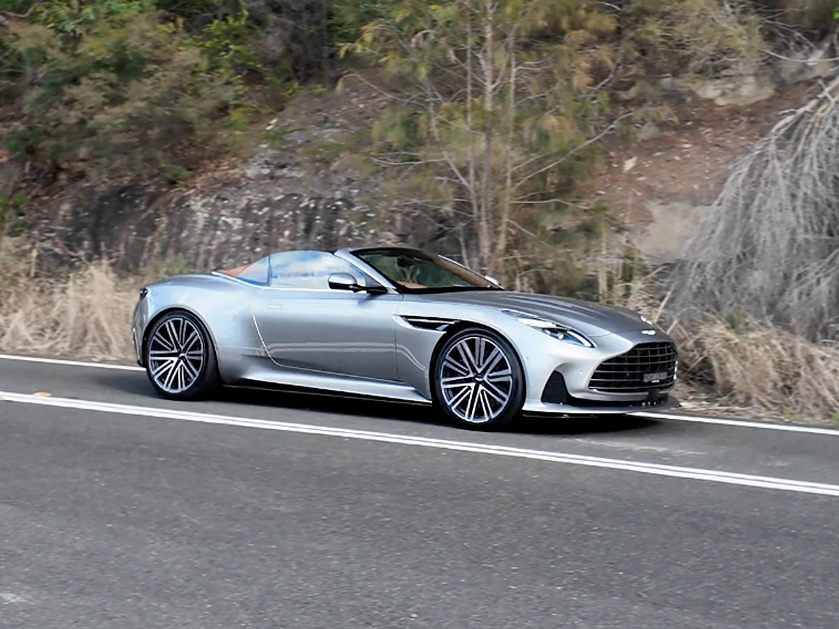 Aston martin db12 volante driving on road