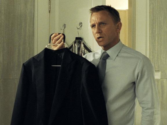 Daniel Craig holding a suit