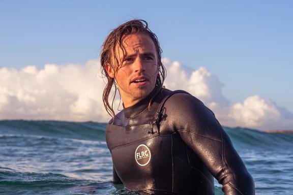 A model in sea wearing an FLRC wetsuit