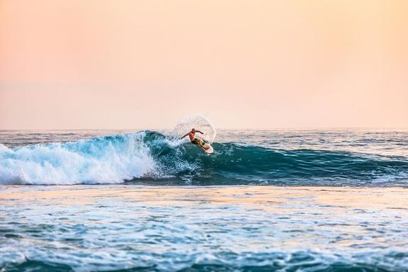 man surfing on a large wave