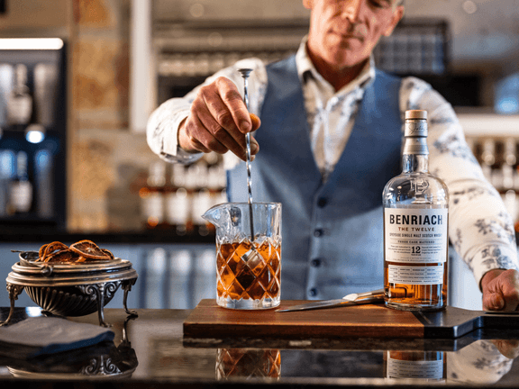 A man stirring a single malt whisky from Benriach.