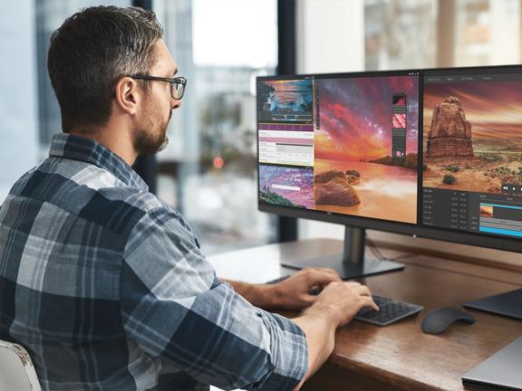 man working with double monitors